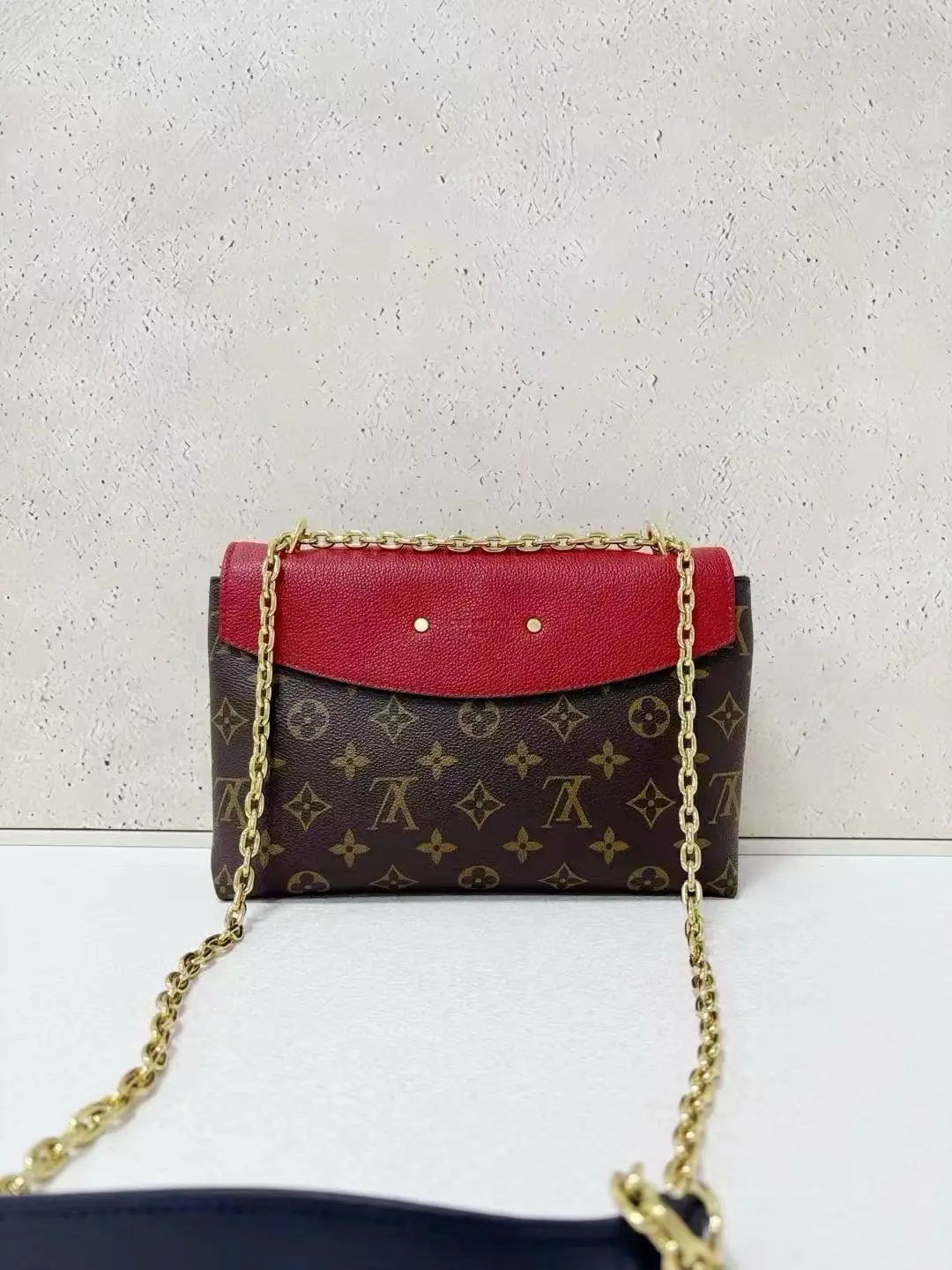LOUIS VUITTON Saint Placide Envelope Bag in Red Monogram Empreinte Leather LOUIS VUITTON Saint Placide Envelope Bag in Red Monogram Empreinte Leather
